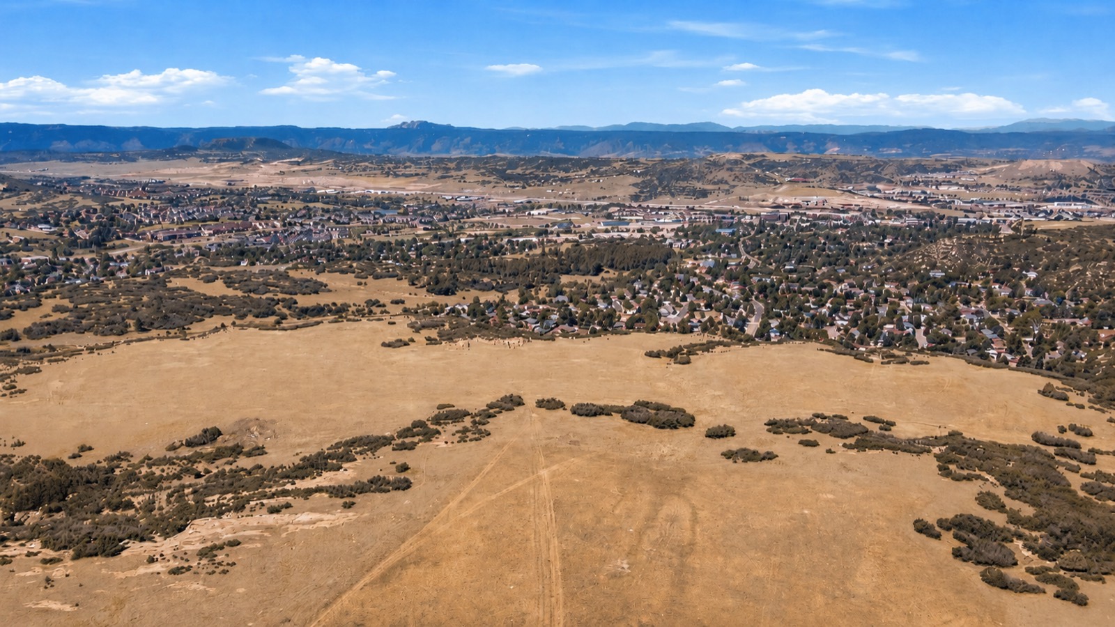 Aerial view of the property with Castle Rock and the Front Range beyond